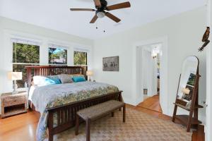 a bedroom with a bed and a ceiling fan at Twin Elm Cottage in Canyon Lake