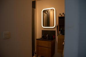 a bathroom with a sink and a mirror on the wall at Chambre d hôte in Saint-Herblain