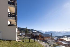 a view from the side of a building with mountains in the background at Studio Les Saisies in Hauteluce