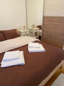 two towels are sitting on a bed in a room at Pranjić Apartment in Zaprešić