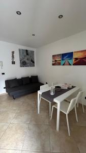 a living room with a table and a couch at Elly’s House in Bari