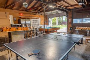 a ping pong table in the middle of a room at Campau Lake Sunshine cottage in Cascade