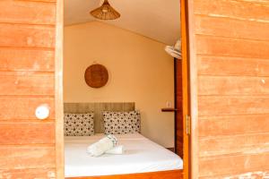 a bedroom with a bed in a small room at Family Guest House in Ilha de Boipeba