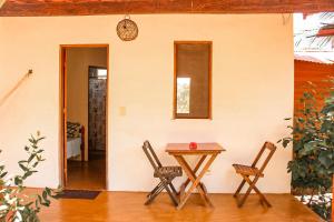 a table and two chairs in a room at Family Guest House in Ilha de Boipeba +37 photos