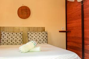 a bedroom with a bed with two pillows at Family Guest House in Ilha de Boipeba