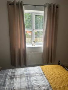 a bedroom with a bed in front of a window at Immaculate house in Doncaster in Cantley