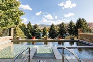 a swimming pool with a view of trees and mountains at Incredible 4BD Mtn Penthouse with Pool and Hot Tub, AC in Avon