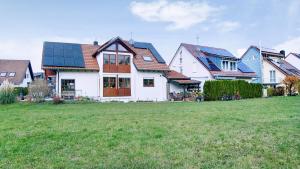 a group of houses with solar panels on their roofs at Haus Heinemann in Stegen