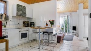 a kitchen with a table and chairs in a room at Haus Heinemann in Stegen