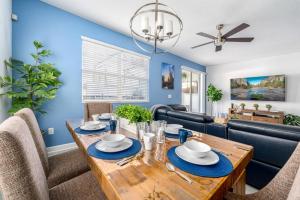 a dining room and living room with a table and chairs at New - Champions Gate 5-Bedroom in Davenport