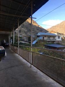 a building with a fence with a view of a mountain at HOUSE ON THE ROCK in Meghri