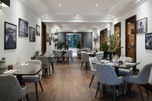 a restaurant with tables and chairs and pictures on the walls at Delta Hotels by Marriott Bristol City Centre in Bristol
