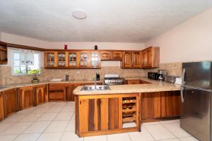 a kitchen with wooden cabinets and a stainless steel refrigerator at Belle Air Seaview ( 2 Bdrm -2 Bath) in Runaway Bay