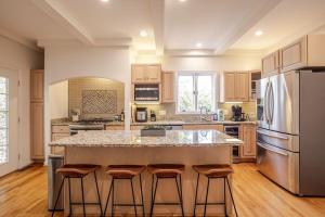 a kitchen with a large island with bar stools at Private, Serene Mt Lookout 5B Retreat with Garage, EV Charging in Cincinnati