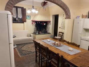 a kitchen and living room with a table and a fireplace at Agriturismo Podere Delle Querci in Castiglion Fiorentino