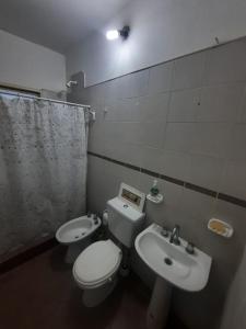 y baño con aseo y lavamanos. en casa familiar confortable en Santiago del Estero