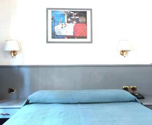 Giường trong phòng chung tại Hotel Vitruvio