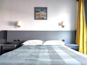 Giường trong phòng chung tại Hotel Vitruvio