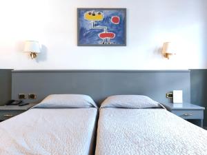 Giường trong phòng chung tại Hotel Vitruvio