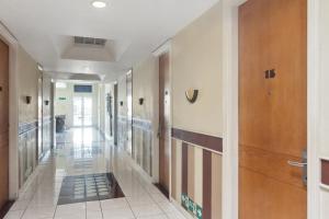 a hallway of a building with a hallway at Puri Sawo Manila Residence in Jakarta