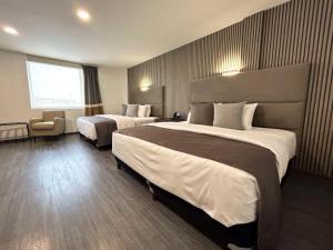 Postel nebo postele na pokoji v ubytování HUNICO HOTEL