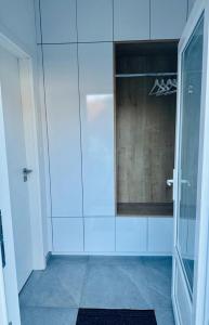 La salle de bains est pourvue d'une douche en verre avec une porte en verre. dans l'établissement Studio apartman, à Kőszeg