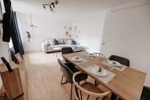 a dining table and chairs in a living room at Altstadt Apartment Lemgo in Lemgo