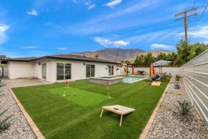 a backyard with a lawn with miniature golf at NEW Sip Sip Away A Vibrant Pool and Hot Tub Retreat in Palm Springs
