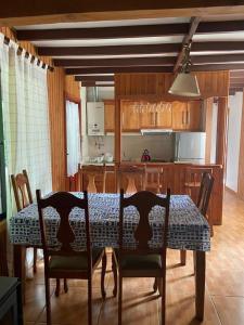 a dining room table and chairs in a kitchen at CASA in Pucón