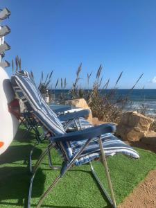 two chairs sitting on the grass near the ocean at Andalusian Lifestyle in Marbella
