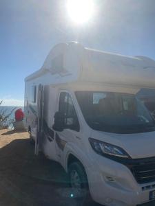 a white camper truck parked on the beach at Andalusian Lifestyle in Marbella