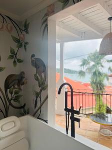 a kitchen with monkeys painted on the wall at The Pink Palm Hotel - Adults Only in Charlotte Amalie