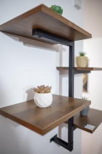 a wooden shelf with a bowl on a wooden table at Spacious 2 Bedroom 6 Minute Drive from Huddersfield Town Centre - Ideal Stay in Huddersfield