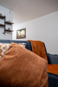 a room with a bed and a clock on the wall at Spacious 2 Bedroom 6 Minute Drive from Huddersfield Town Centre - Ideal Stay in Huddersfield