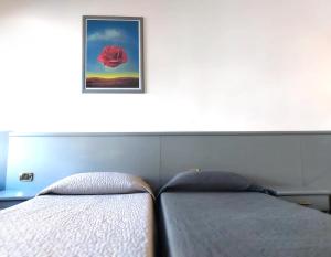 Giường trong phòng chung tại Hotel Vitruvio