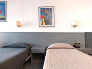 Giường trong phòng chung tại Hotel Vitruvio