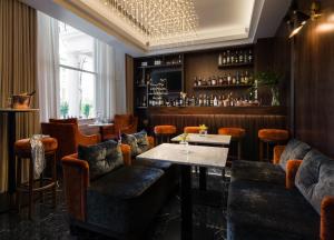 a restaurant with a table and chairs and a bar at Montcalm Chilworth Townhouse, Paddington in London