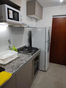 a kitchen with a refrigerator and a stove top oven at La Plaza in Sunchales