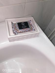 a box of soap sitting on top of a toilet at Xenia's studio in Chalkida