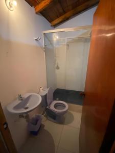 a bathroom with a toilet and a sink at FINCA LA FORTALEZA in Santa Rosa de Cabal