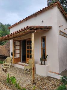 a small white house with a cactus at INZU Lodge in Gisenyi