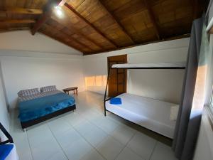 a bedroom with two bunk beds and a table at FINCA LA FORTALEZA in Santa Rosa de Cabal