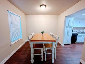 a dining room with a table and white chairs at Workforce Ready 2 bedroom in Corpus Christi