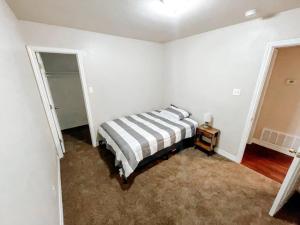 a bedroom with a bed with a striped blanket at Workforce Ready 2 bedroom in Corpus Christi