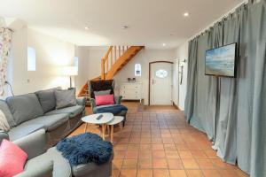 een woonkamer met een bank en een tafel bij Juwel am Deich in Emmelsbüll-Horsbüll