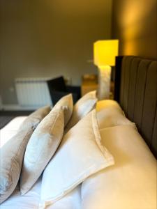 a pile of pillows on top of a bed at Castle Rise in Hull