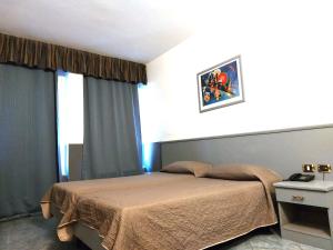 Giường trong phòng chung tại Hotel Vitruvio