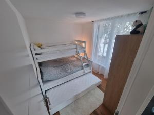 a small room with a bunk bed with a window at Bjelasnica view lodge in Bjelašnica