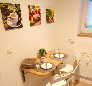 a table with two chairs and a cup of coffee at Long Stay Appartement Kiel in Kiel