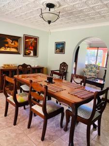 a dining room with a wooden table and chairs at Casa Mano de Tigre in Potrerillos
